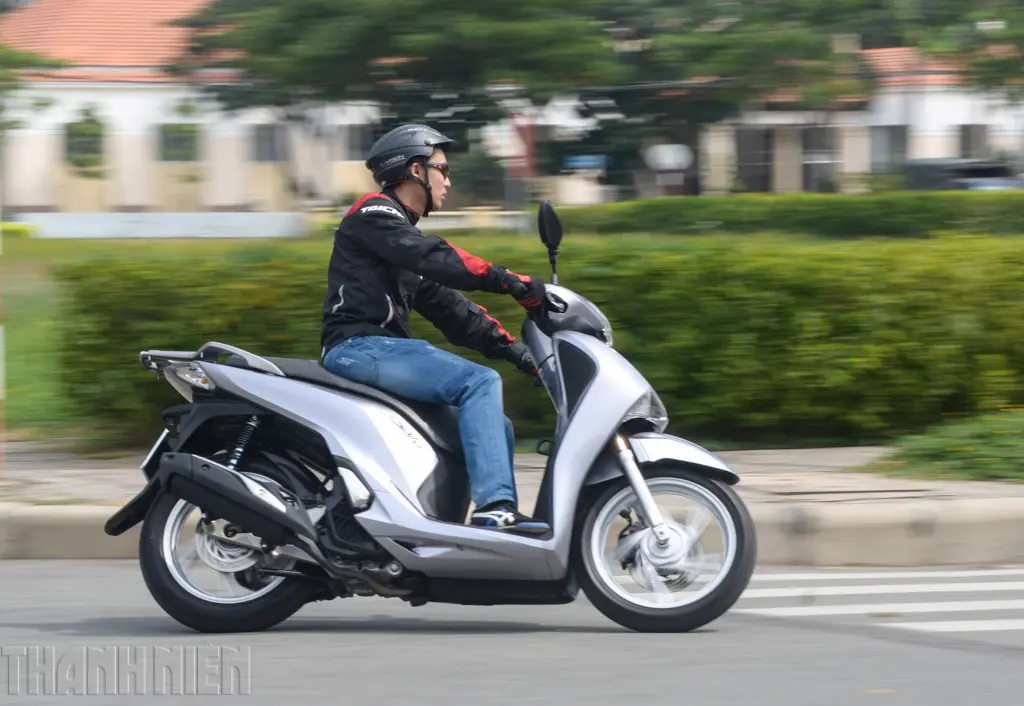 Một người đang đánh giá chi tiết tình trạng của xe SH 150i 2017 cũ